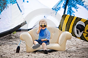 Adorable kiteboarder boy in the chair
