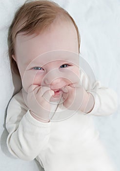 Adorable laughing baby boy lying