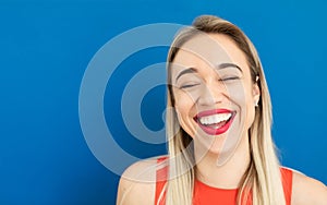 Adorable laughing blonde woman with wide red lips smile.