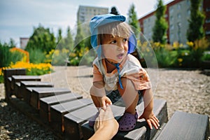 Adorable little 1-2 year old toddler boy having fun on playground in Krakow, Poland