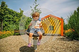 Adorable little 1-2 year old toddler boy having fun on playground in Krakow, Poland