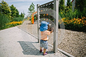 Adorable little 1-2 year old toddler boy having fun on playground in Krakow, Poland