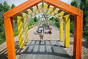 Adorable little 1-2 year old toddler boy having fun on playground in Krakow, Poland