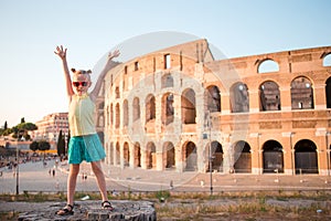 Adorable little active girl having fun in front of Colosseum in Rome, Italy.