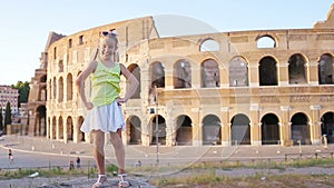 Adorable little active girl having fun in front of Colosseum in Rome, Italy. Kid spending childhood in Europe