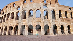 Adorable little active girl having fun in front of Colosseum in Rome, Italy. Kid spending childhood in Europe