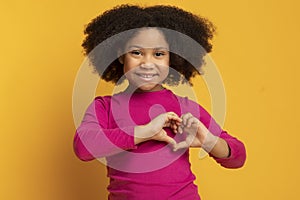 Adorable Little African American Girl Showing Heart Gesture With Hands