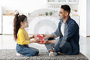 Adorable Little Arab Girl Giving Present To Dad, Greeting With Father's Day