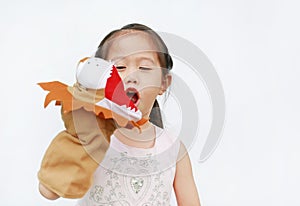 Adorable little Asian child girl hand wear and playing Lion puppets on white background. Educations concept photo