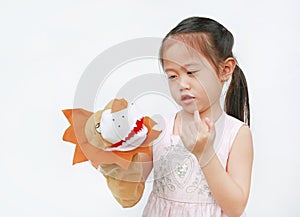 Adorable little Asian child girl hand wear and playing Lion puppets on white background. Educations concept photo