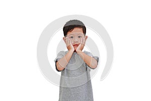 Adorable little baby boy with hands touching his cheek looking straight at camera on white isolated background with clipping path