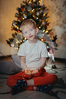 adorable little baby boy sitting in front of a christmas tree. Christmas Child Open Present Gift, Happy Baby Boy looking