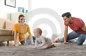 Adorable little baby crawling near parents