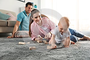 Adorable little baby crawling near parents