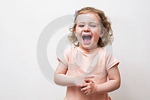 Adorable little baby girl laughing and playing in the studio, isolated on white background