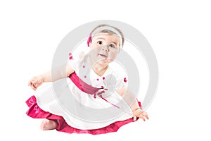 Adorable little baby girl playing in the studio, isolated on white background.