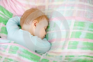 Adorable little baby girl sleeping in bed. Calm peaceful child dreaming during day sleep. Beautiful baby in parents bed