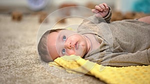 Adorable little baby lying, birth statistics and governmental children aid