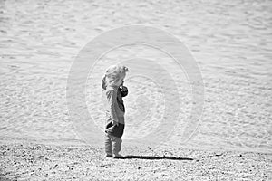 Adorable little blond kid boy at ocean beach