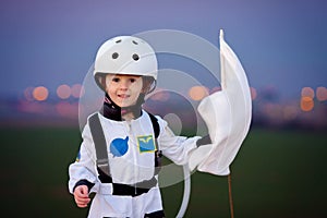 Adorable little boy, dressed as astronaut, playing in the park w