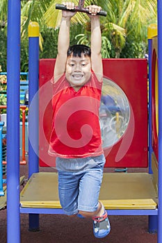 Adorable little boy gliding on the flying fox