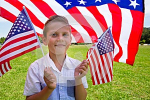 Adorable little boy holding american flag outdoors on beautiful summer day