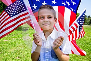 Adorable little boy holding american flag outdoors on beautiful summer day