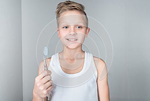 adorable little boy holding toothbrush and smiling photo