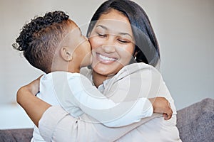 Adorable little boy kissing his mother on the cheek. Happy mixed race mother receiving love and affection from her son