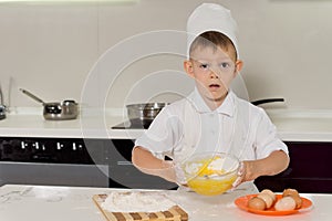 Adorable little boy pastry chef