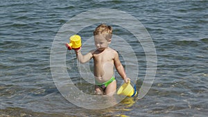Adorable little boy playing in the sea