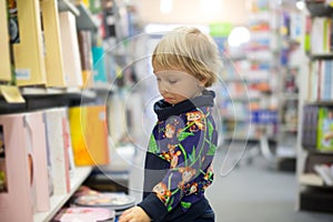 Adorable little boy, sitting in a book store