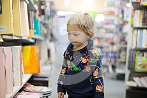 Adorable little boy, sitting in a book store