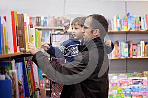 Adorable little boy, sitting in a book store