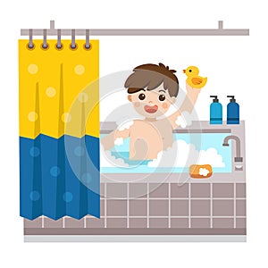 Adorable little boy taking a bath in bathtub with lot of soap lather and rubber duck. photo