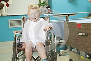 Adorable little boy in the wheelchair at the