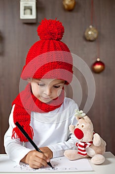 Adorable little boy, writing letter to Santa