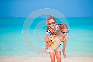 Adorable little caucasian girls at beach during summer vacation. Happy kids having fun together on their family summer