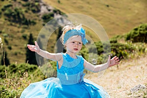 Adorable little child girl with bubble blower on grass on meadow. Summer green nature