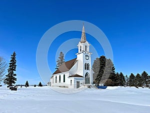 An adorable little country church surrounded by fresh snow
