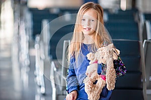 Adorable little girl in airport indoor before boarding