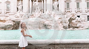Adorable little girl background Trevi Fountain, Rome, Italy.