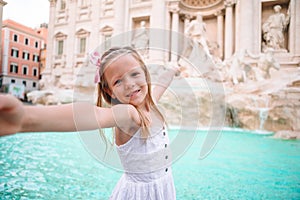 Adorable little girl background Trevi Fountain, Rome, Italy.