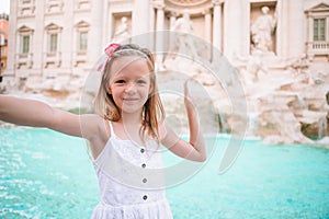 Adorable little girl background Trevi Fountain, Rome, Italy.