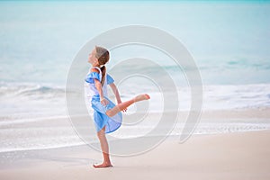 Adorable little girl on the beach. Happy girl enjoy summer vacation background the blue sky and turquoise water in the