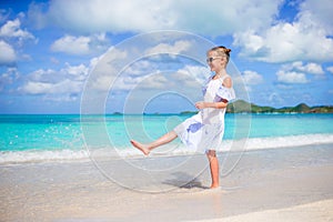 Adorable little girl on the beach. Happy girl enjoy summer vacation background the blue sky and turquoise water in the