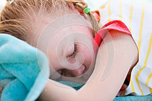 Adorable little girl at beach sleeping