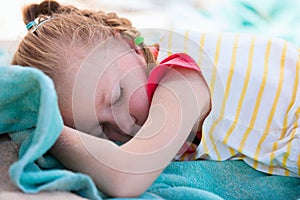 Adorable little girl at beach sleeping