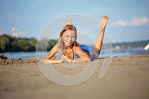 Adorable little girl at beach during summer vacation