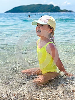 Adorable little girl at beach during summer vacation